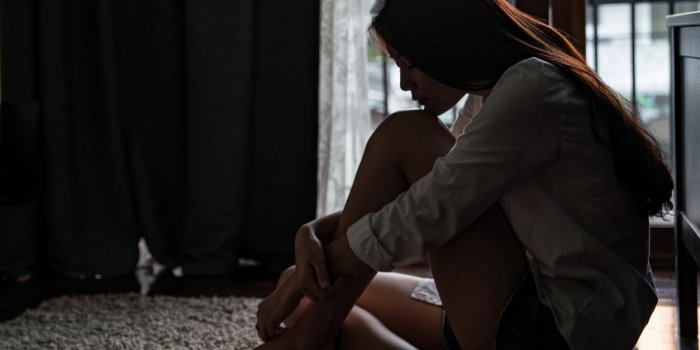 selective focus loneliness young asian woman sitting on bedroom floor near the balcony depression sadness breaking up asi...