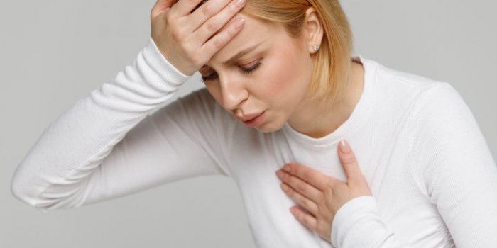breathing, respiratory problem, asthma attack, pressure, chest pain, sun stroke, dizziness concept studio portrait of wom...