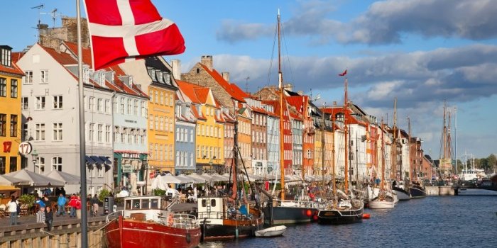copenhagen, denmark - august 25 unidentified people enjoying sunny weather in open cafees of the famous nyhavn promenade...
