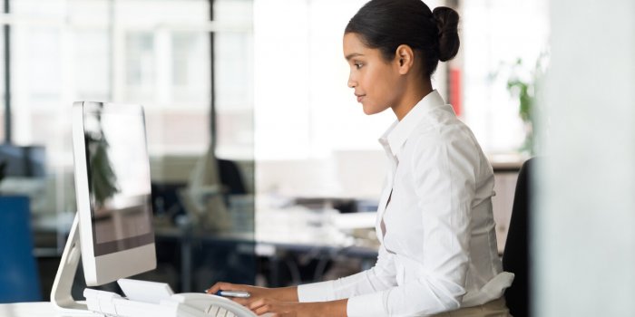 multi ethnic business woman working with computer at the office focused young businesswoman checking email with laptop of...
