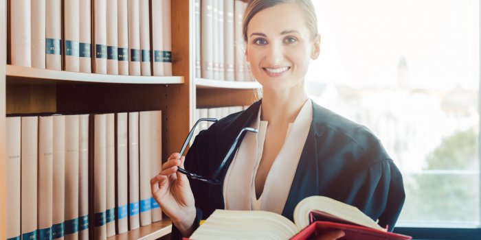 lawyer working on a difficult case reading in the library of law firm