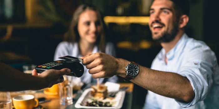 man paying bill at fancy restaurant