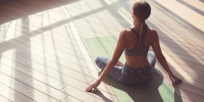 young girl doing yoga in the sunlight