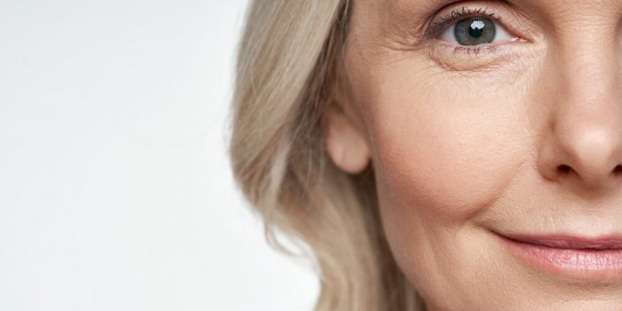 50s middle aged old woman looking at camera isolated on white background advertising dry skin care treatment anti age ski...