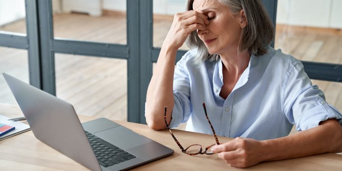 overworked tired older lady holding glasses feeling headache, having eyesight problem after computer work stressed mature...
