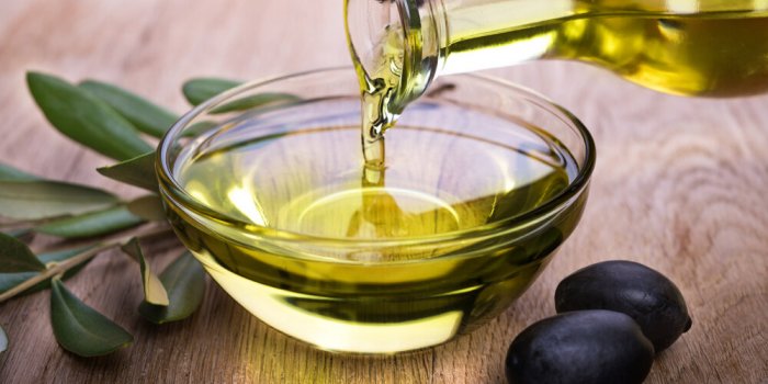 bowl with olive oil on wooden table