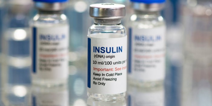 insulin vials on meal tray with glass vials in background