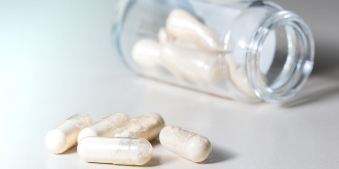 yellow transparent antibiotics capsule in glass bottle