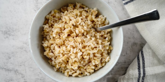 cooked brown rice served in a bowl, selective focus