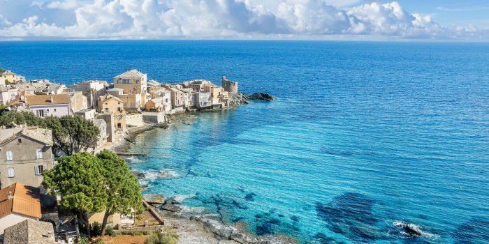 landscape with erbalunga, ancient village in corsica island, french