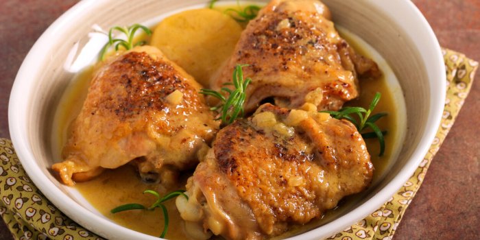 curry coconut milk chicken thighs on plate