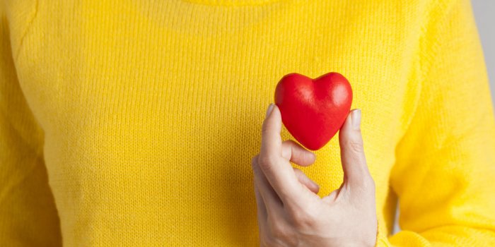 female hand holding red heart, love concept for valentines day with sweet and romantic moment