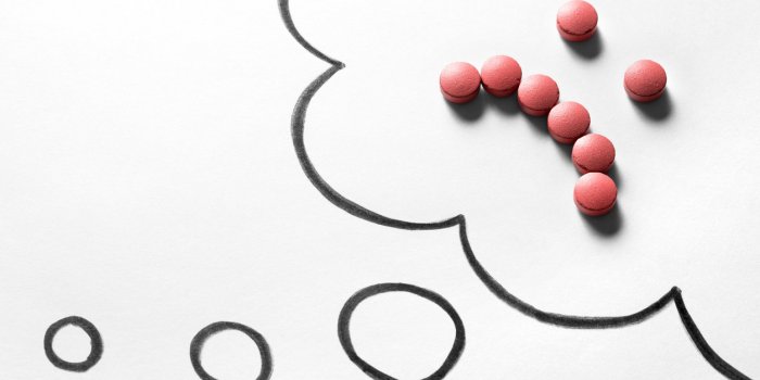 sad smiley face made from pills on hand drawn thinking speech bubble and thought cloud clinical depression, mental illnes...