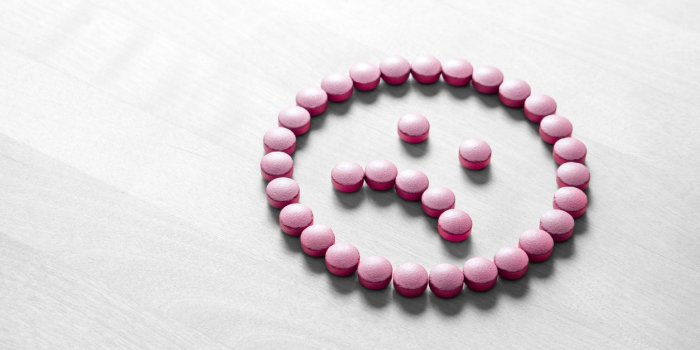 clinical depression, mental illness and disorder or bad health services concept sad smiley face made from pills, medicine...