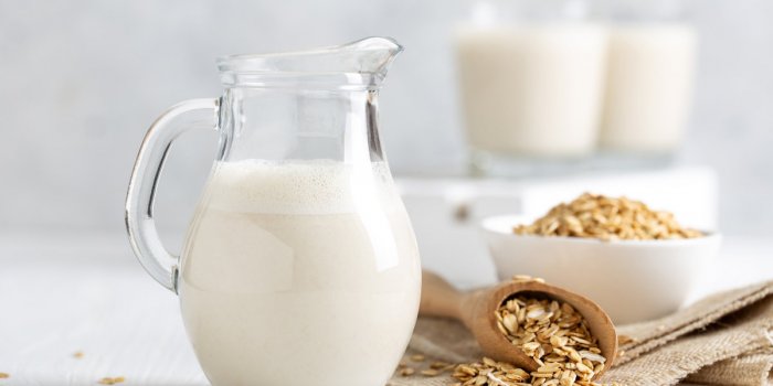 oat milk healthy vegan non-dairy organic drink with flakes