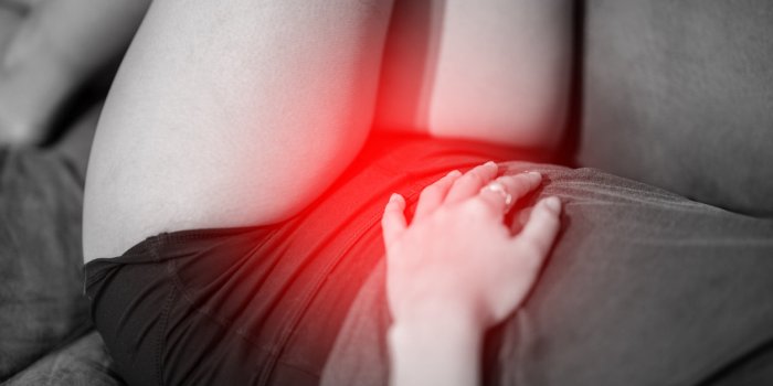 woman have bladder pain or uti pain sitting on bed in bedroom after wake up feeling so illness,healthcare concept