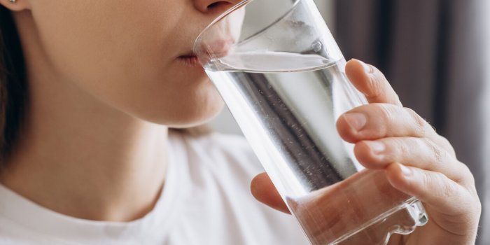 side view close up of healthy young female drinking pure still water in morning caucasian lady enjoying healthy lifestyle...