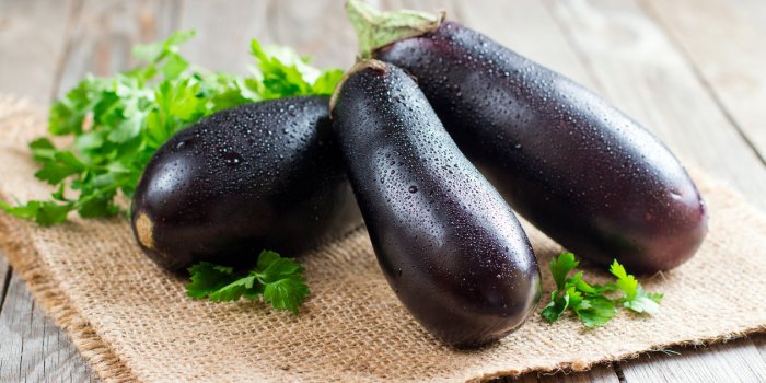 fresh eggplant on wooden background