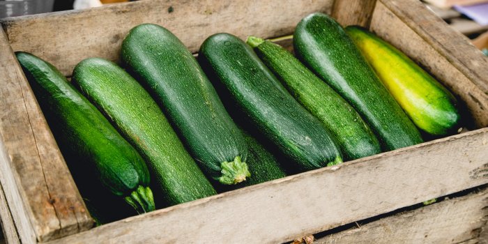 zucchinis in wooden box at the market