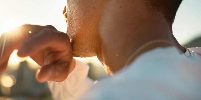 chin, hand and sweating with sports person outdoor in nature closeup for exercise or fitness cardio, challenge and intens...