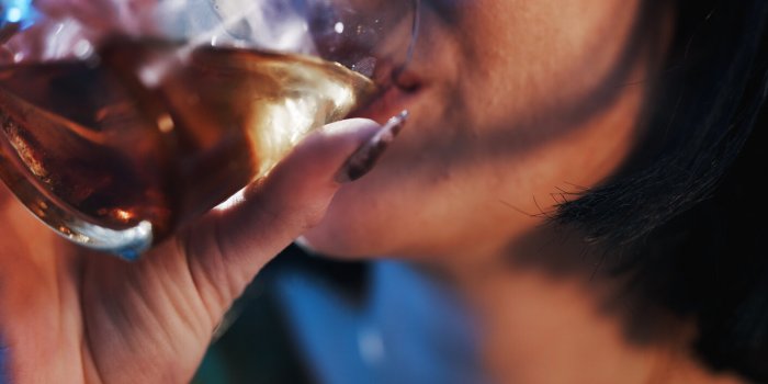 mouth, woman and glass with whiskey for alcohol abuse or addiction as stress relief for mental health closeup, female per...