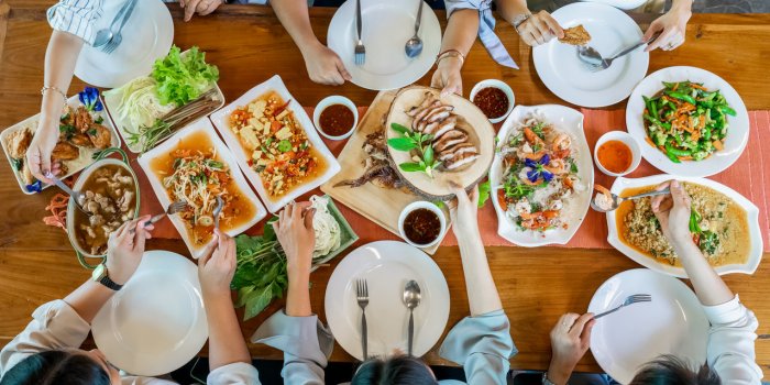 topview of thai local food such as somtum papaya spicy salad, grilled pork, tomyum, vegetable and shrimp curry are arrang...