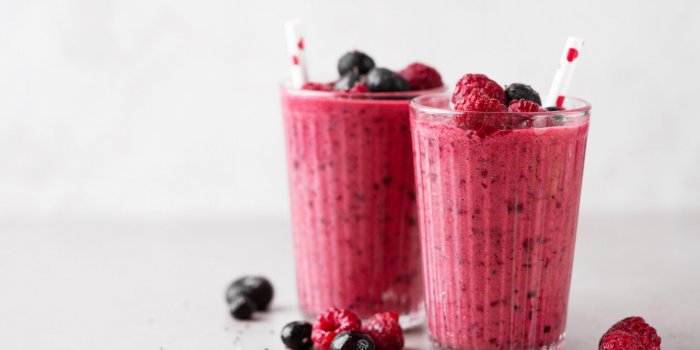 tasty healthy dieting red berry smoothie with chia seeds in glasses on grey background closeup with copy space