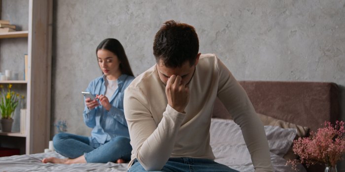 upset annoyed man offended on wife caucasian family couple in bedroom woman gadget addicted use mobile phone chatting in ...