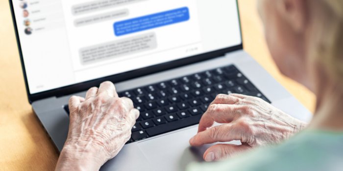 chat messages in laptop of an old woman love fraud scam of catfish elder person in online conversation with family grandm...