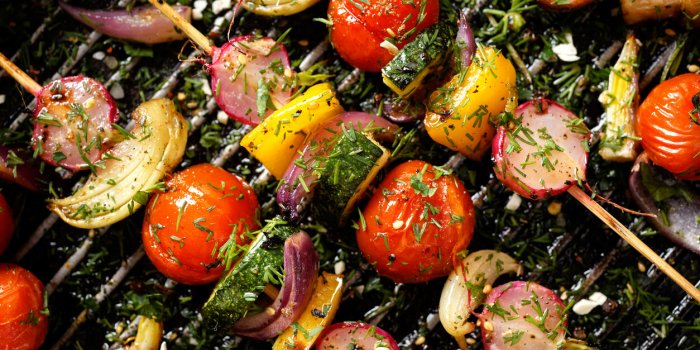 grilled veggie skewers with cherry tomatoes, radishes, peppers and onions with fresh dill on a grill pan