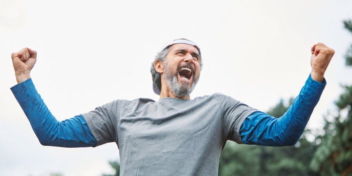 senior man running exercising sport fitness screaming power strength anger champion