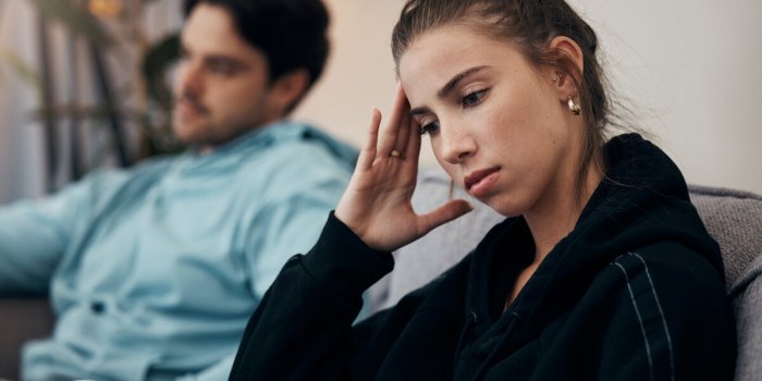 frustrated couple, headache and fight on sofa in divorce, disagreement or conflict in living room at home man and woman i...