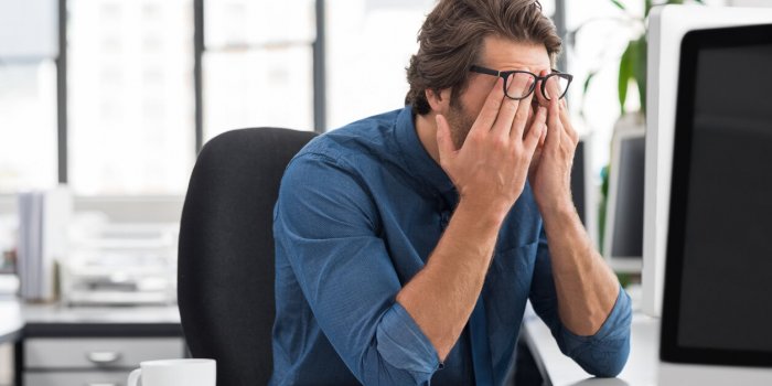 portrait of an upset businessman at desk in office businessman being depressed by working in office young stressed busine...