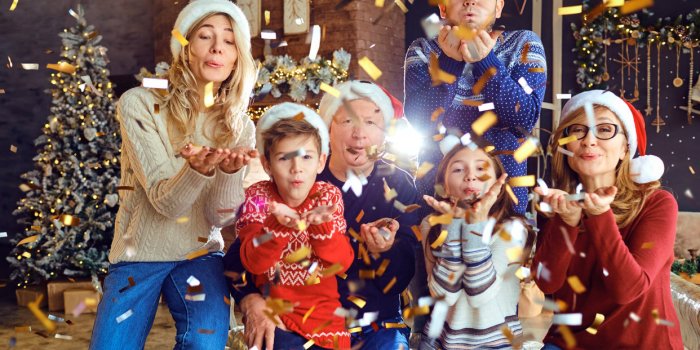 big happy family blowing confetti at home for christmas new year celebration in the family