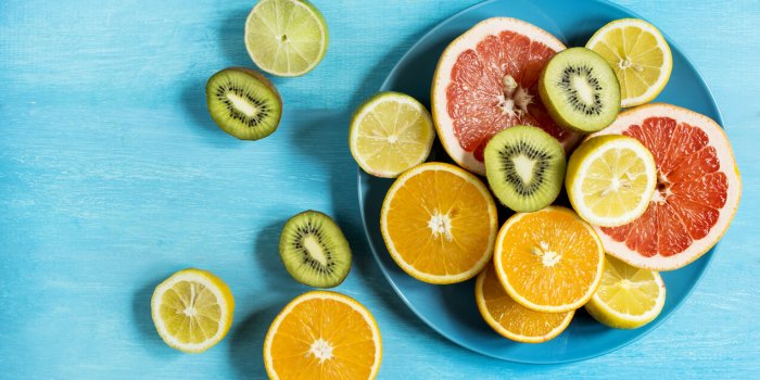citrus fruit cut half on a blue table top view