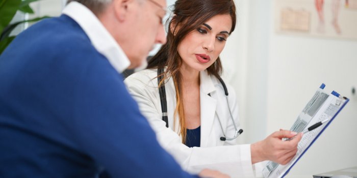 doctor showing an examination report to her patient