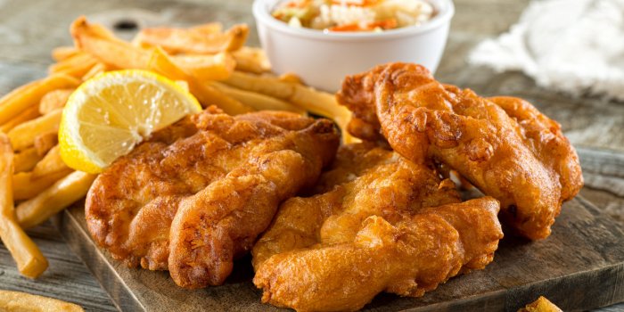 delicious homemade fish and chips with coleslaw and lemon garnish