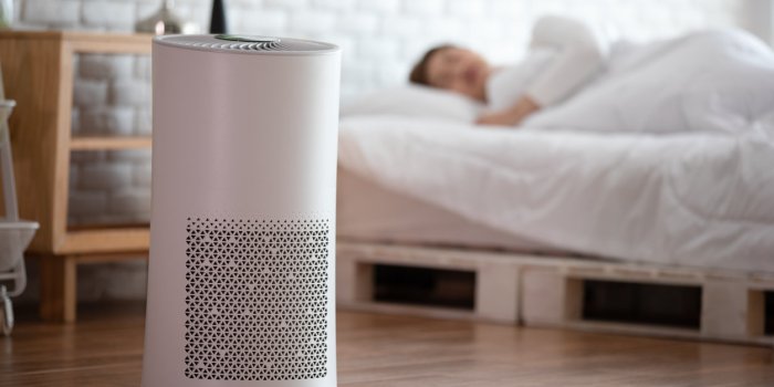 woman sleep with air purifier in cozy white bed room for filter and cleaning removing dust pm25 hepa in home,for fresh ai...