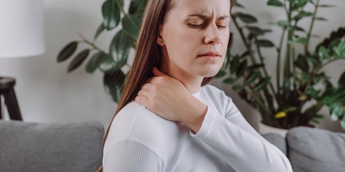close up of tired unhappy young woman feeling exhausted and suffering from neck pain, sad unhealthy caucasian doing massa...