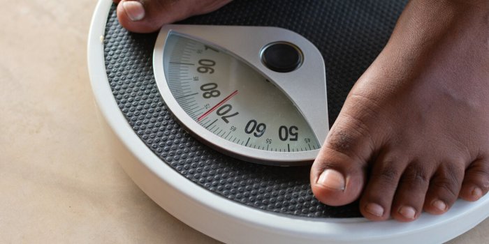 male on the weight scale for check weight diet and weight control concept