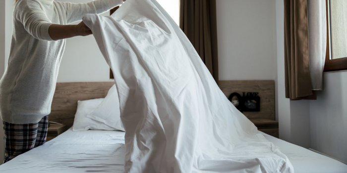 maid cleaning messy hotel room selective focus copy space