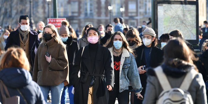 paris, france-03 06 2021 people wearing protective face masks in a crowded street of paris, france during the global coro...