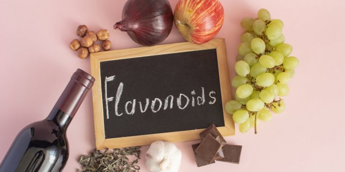 products containing flavonoids in their composition grapes, onions, garlic, chocolate, tea, close-up on a light backgroun...